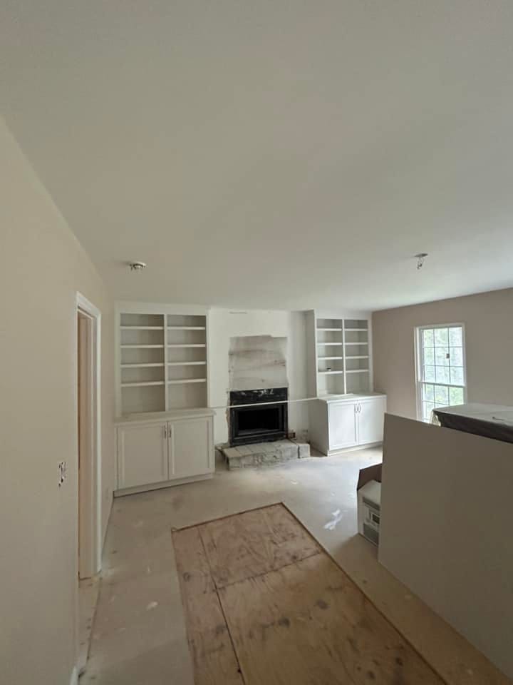 Custom built-in cabinetry and fireplace surround installation during residential interior remodel in Aiken, SC home construction project.